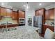 Modern kitchen featuring granite counters, stainless steel appliances, and a walk-in pantry at 113 Market Cross Ct, Holly Springs, NC 27540