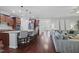 Open-concept kitchen, living room and dining room featuring a granite island, stainless appliances and ample seating at 113 Market Cross Ct, Holly Springs, NC 27540