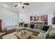 Spacious living room with open access to a kitchen and a dining area, complete with a large sectional sofa at 113 Market Cross Ct, Holly Springs, NC 27540