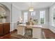Well-lit office with a spacious desk, custom built-ins, and elegant trim for a sophisticated workspace at 113 Market Cross Ct, Holly Springs, NC 27540