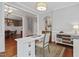 Bright office space with hardwood floors and neutral walls, adjacent to the dining area at 113 Market Cross Ct, Holly Springs, NC 27540