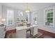Bright office featuring a large desk, ample natural light, and neutral décor for a productive workspace at 113 Market Cross Ct, Holly Springs, NC 27540