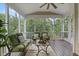 Cozy screened porch with comfortable seating, ceiling fan, and peaceful outdoor views at 113 Market Cross Ct, Holly Springs, NC 27540