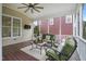 Relaxing screened porch with comfortable seating, a ceiling fan, and serene views at 113 Market Cross Ct, Holly Springs, NC 27540