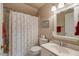 Bathroom with tub/shower, white vanity, and a palm tree themed shower curtain at 116 Berry Hill Dr, Raleigh, NC 27615