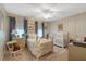 Charming bedroom with striped wallpaper, a crib, a bed and a ceiling fan at 116 Berry Hill Dr, Raleigh, NC 27615