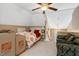 Spacious bedroom featuring plush bedding, a ceiling fan and an adjacent sitting area at 116 Berry Hill Dr, Raleigh, NC 27615
