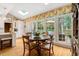 Sunlit breakfast nook featuring a round table and expansive windows overlooking the outdoor deck at 116 Berry Hill Dr, Raleigh, NC 27615