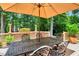 Outdoor dining on a wooden deck with an umbrella table at 116 Berry Hill Dr, Raleigh, NC 27615