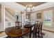 Elegant dining room featuring a chandelier, hardwood floors, and staircase access to the second floor at 116 Berry Hill Dr, Raleigh, NC 27615