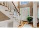 Bright foyer features hardwood floors, stairs, and a view of the front door at 116 Berry Hill Dr, Raleigh, NC 27615