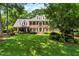 Charming brick home boasts lush lawn, manicured landscaping, and black shutters at 116 Berry Hill Dr, Raleigh, NC 27615