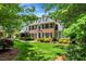 Charming brick home features lush green lawn and mature landscaping at 116 Berry Hill Dr, Raleigh, NC 27615