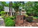Brick home with well-manicured landscaping and a driveway entrance at 116 Berry Hill Dr, Raleigh, NC 27615