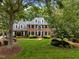 Charming brick home boasts lush lawn, manicured landscaping, and black shutters at 116 Berry Hill Dr, Raleigh, NC 27615