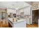 Bright, modern kitchen with a large island, white cabinetry, and hardwood floors at 116 Berry Hill Dr, Raleigh, NC 27615