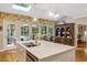 Bright kitchen featuring a large island with sink, skylight, and French doors at 116 Berry Hill Dr, Raleigh, NC 27615