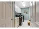 Functional laundry room with modern appliances, white cabinets, and striped wallpaper at 116 Berry Hill Dr, Raleigh, NC 27615