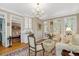 Open living area with a wet bar including a wine cooler and ample cabinetry at 116 Berry Hill Dr, Raleigh, NC 27615