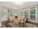 Bright sitting room with a chandelier, shuttered windows and an plush area rug at 116 Berry Hill Dr, Raleigh, NC 27615