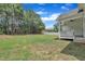 The backyard features a well-manicured lawn and a view of the surrounding trees and fencing at 119 Blossom Creek Dr, Garner, NC 27529
