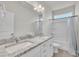 Bathroom features a double sink vanity with granite countertop and white cabinets alongside a shower and toilet at 119 Blossom Creek Dr, Garner, NC 27529