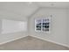 Cozy bedroom with neutral walls and carpet, a large window, and a white dry erase board at 119 Blossom Creek Dr, Garner, NC 27529