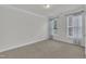 Bright and airy bedroom with neutral carpet, natural light from two windows, and simple, stylish curtains at 119 Blossom Creek Dr, Garner, NC 27529