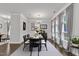 Elegant dining room with large windows, chandelier, and dark wood table and chairs, perfect for entertaining at 119 Blossom Creek Dr, Garner, NC 27529