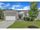 Charming single-story home with a stone facade, two-car garage, and well-maintained lawn at 119 Blossom Creek Dr, Garner, NC 27529