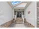 Inviting front porch with stone steps, black double doors, and white wood pillars at 119 Blossom Creek Dr, Garner, NC 27529