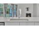 Modern kitchen features white cabinets, stainless steel appliances, and stone countertops with a view to the deck at 119 Blossom Creek Dr, Garner, NC 27529