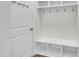 Bright mudroom features white bench with storage and cubbies with hooks for added functionality and organization at 119 Blossom Creek Dr, Garner, NC 27529