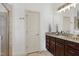 Bathroom featuring a granite-topped vanity with dark wood cabinets and a glass-enclosed shower at 1217 Chalk Maple Dr, Cary, NC 27519