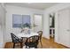 Well-lit dining area featuring a white table, black chairs, and an adjacent half bathroom at 1217 Chalk Maple Dr, Cary, NC 27519