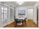 Bright dining area with white round table, black chairs, and access to the outdoor patio at 1217 Chalk Maple Dr, Cary, NC 27519