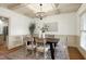 Elegant dining room features a coffered ceiling and stylish chandelier at 1217 Chalk Maple Dr, Cary, NC 27519