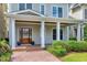 Inviting front porch with brick walkway, decorative plants, and a lovely wooden front door at 1217 Chalk Maple Dr, Cary, NC 27519