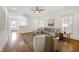Bright living room with hardwood floors, a ceiling fan and a comfortable sectional sofa at 1217 Chalk Maple Dr, Cary, NC 27519