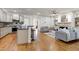Open-concept living area with a modern kitchen and comfortable seating at 1217 Chalk Maple Dr, Cary, NC 27519