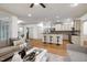 Spacious living room with hardwood floors, bar seating, and a view into the kitchen at 1217 Chalk Maple Dr, Cary, NC 27519