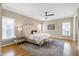 Spacious main bedroom with hardwood floors, ceiling fan, and many windows at 1217 Chalk Maple Dr, Cary, NC 27519