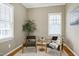 Cozy sitting area with two chairs, a small table, and natural light from the windows at 1217 Chalk Maple Dr, Cary, NC 27519
