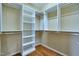 Spacious walk-in closet with ample shelving, hanging rods and hardwood floors at 1217 Chalk Maple Dr, Cary, NC 27519