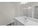 Bright bathroom featuring a sleek vanity with sink and a large mirror above the toilet at 1217 Solace Way, Rolesville, NC 27571