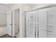 Bright bathroom showcasing a glass-enclosed shower and an open doorway to a walk-in closet at 1217 Solace Way, Rolesville, NC 27571