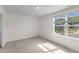 Bright, carpeted bedroom with natural light streaming through a large window at 1217 Solace Way, Rolesville, NC 27571