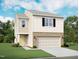 Charming two-story home featuring a brick-accented garage, board and batten siding, and a well-manicured lawn at 1217 Solace Way, Rolesville, NC 27571