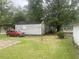 Spacious backyard with a vehicle parked next to an outbuilding at 1256 Planters St, Rocky Mount, NC 27801