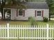 Charming home featuring red shutters and a quaint white picket fence at 1256 Planters St, Rocky Mount, NC 27801